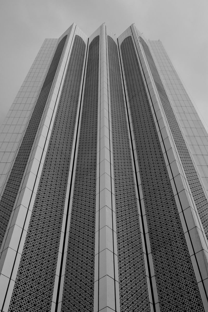 A black and white photo of a skyscraper in Kuala Lumpur, Malaysia