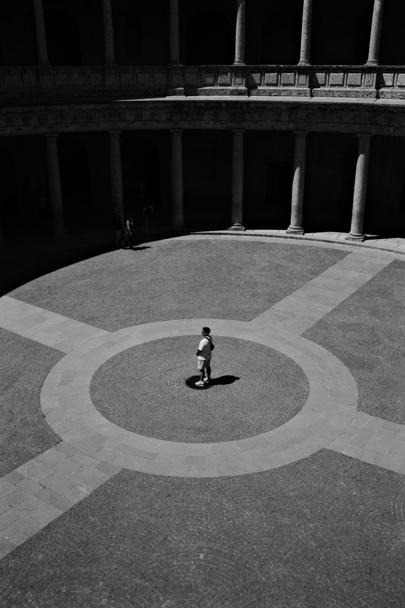 A man standing in the center of an area of the Alhambra in Granada, Spain